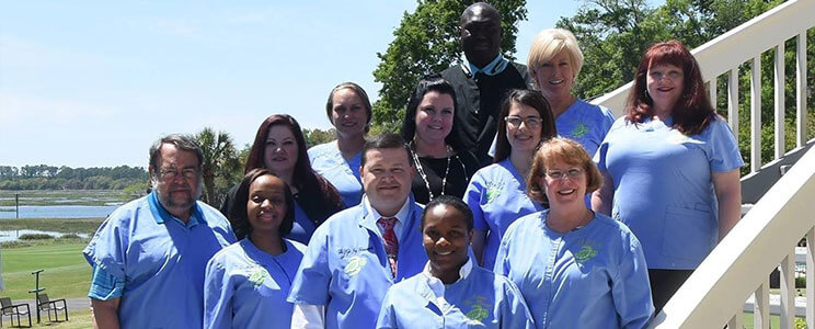 Sea Island Dentistry Dental Team standing outside on the steps of the office